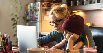 Adult and child looking at a laptop together