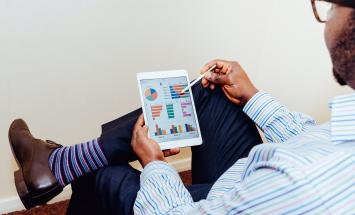 Person holding ipad with graphs