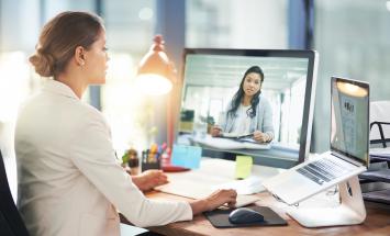 Woman on laptop during a video call at work