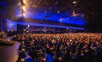 large conference hall filled with people in seats