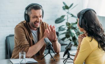 Two people having an interview with microphones